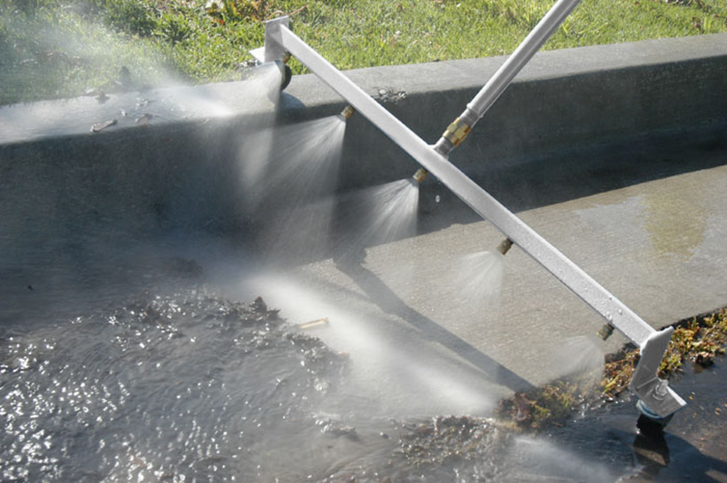 water broom cleaning gutter